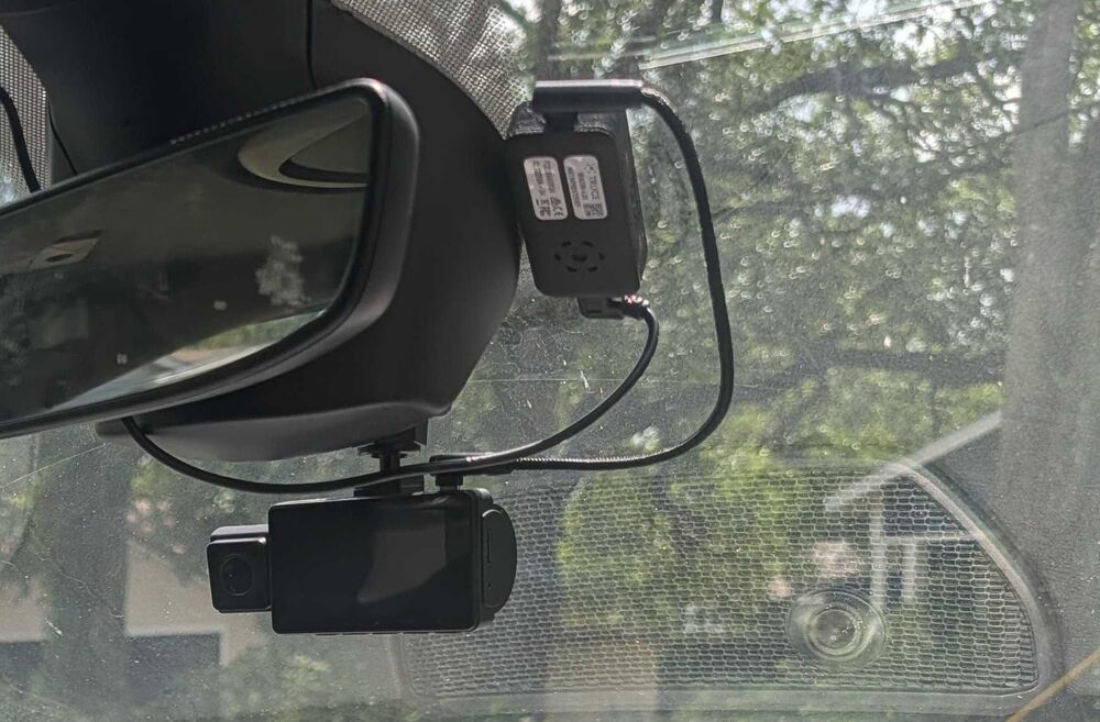TruceVision camera and camera beacon mounted by the rearview mirror with the cable routed up to the headliner